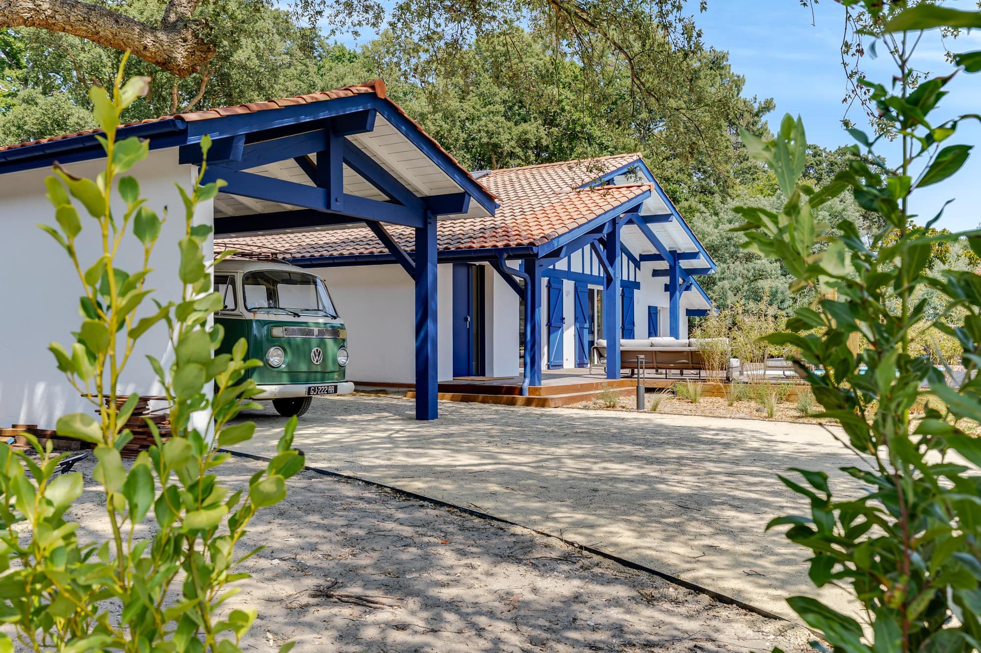 Villa basco-landaise aux volets bleus et son combi Volkswagen vert sous le carport, une location Green Coast à Capbreton
